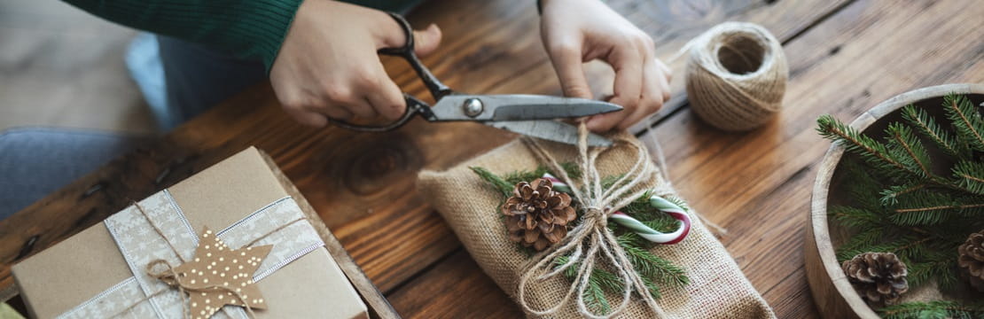 Woman preparing holiday gift with zero waste materials.